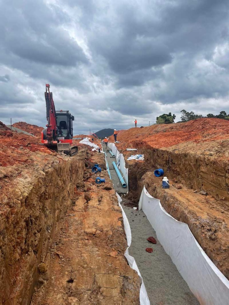 Excavator digging pipework for civil project Sunshine Coast